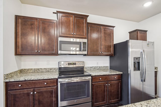 3927 Cannonsgate Ln, Murfreesboro, TN 37128 - kitchen featuring stainless steel appliances, dark brown cabinetry, and light stone countertops