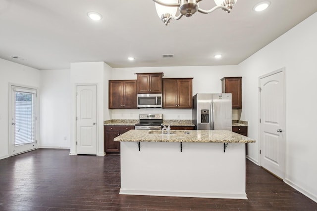 3927 Cannonsgate Ln, Murfreesboro, TN 37128 - kitchen with a chandelier, stainless steel appliances, a kitchen breakfast bar, light stone countertops, and a center island with sink