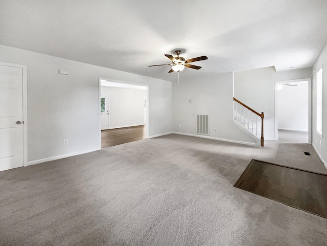 2919 Sams Ct, Spring Hill, TN 37174 - unfurnished living room with ceiling fan, carpet, and stairway