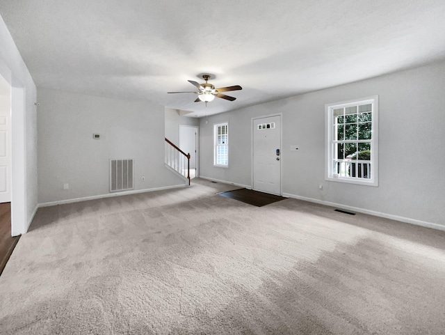 2919 Sams Ct, Spring Hill, TN 37174 - unfurnished living room featuring stairs, carpet, and a ceiling fan