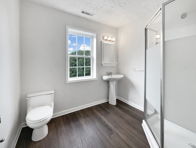 2919 Sams Ct, Spring Hill, TN 37174 - bathroom featuring wood finished floors, a stall shower, and a textured ceiling