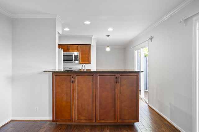 1900 Richard Jones Rd Unit X2, Nashville, TN 37215 - kitchen with ornamental molding, dark wood-style flooring, stainless steel microwave, dark stone counters, and a peninsula