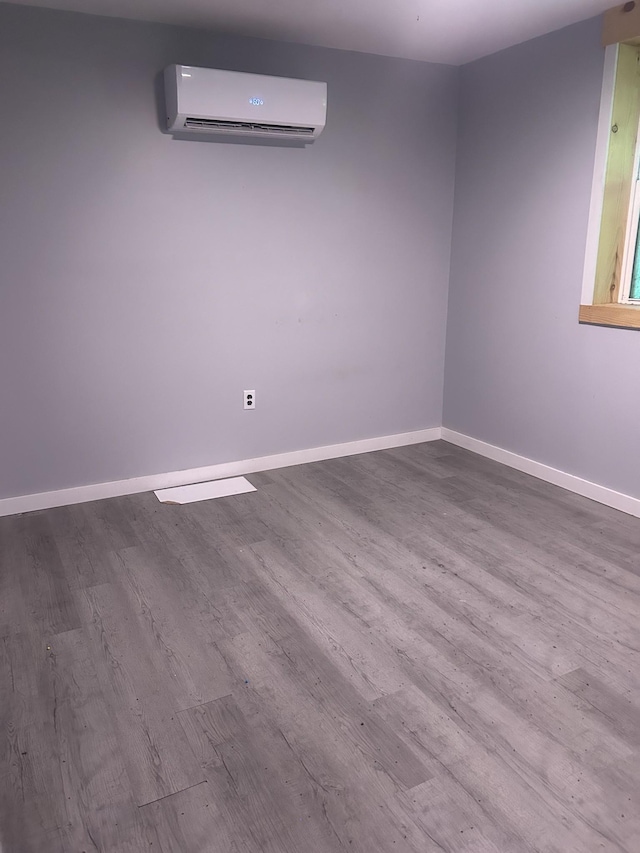 370 Alpine Rd, Camden, TN 38320 - spare room featuring wood finished floors and a wall mounted air conditioner