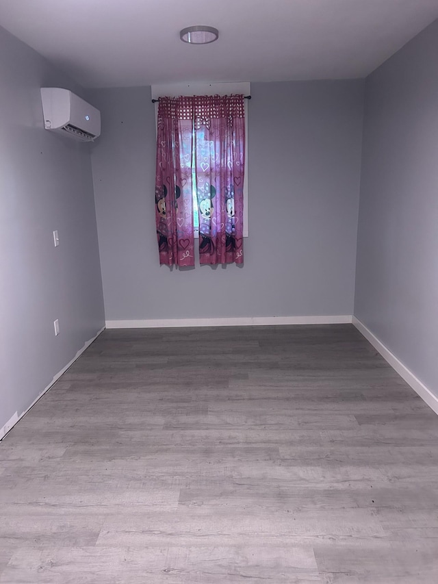 370 Alpine Rd, Camden, TN 38320 - empty room with wood finished floors and a wall mounted AC