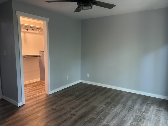 370 Alpine Rd, Camden, TN 38320 - unfurnished bedroom featuring a spacious closet, dark wood-type flooring, and a ceiling fan