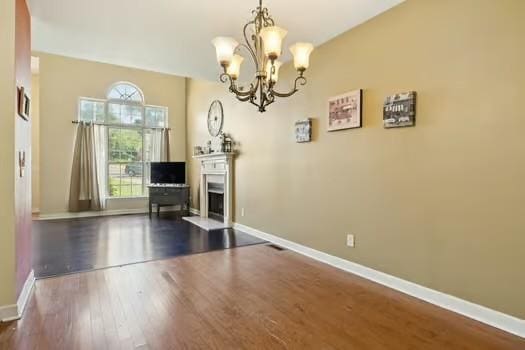 1604 Yarmouth Ct, Old Hickory, TN 37138 - dining area with a chandelier, dark wood-style floors, and a fireplace with raised hearth