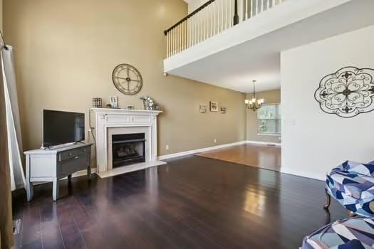 1604 Yarmouth Ct, Old Hickory, TN 37138 - living room featuring a fireplace, a chandelier, a high ceiling, and wood finished floors