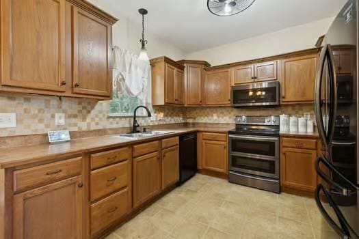 1604 Yarmouth Ct, Old Hickory, TN 37138 - kitchen featuring black appliances, hanging light fixtures, decorative backsplash, and brown cabinets
