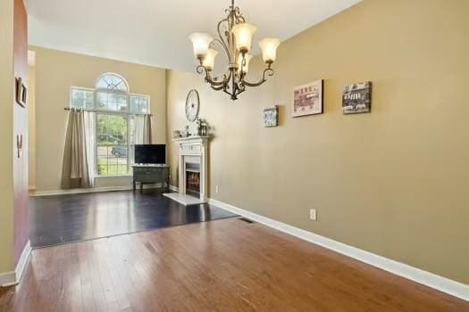 1604 Yarmouth Ct, Old Hickory, TN 37138 - dining space featuring a chandelier, dark wood finished floors, and a fireplace with raised hearth