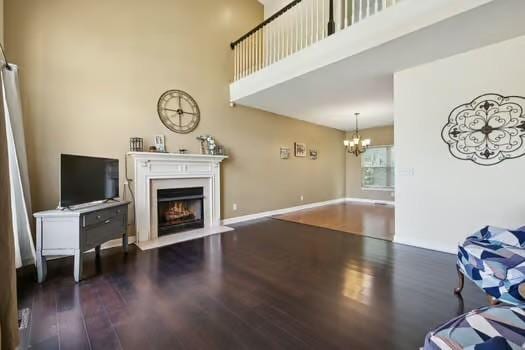 1604 Yarmouth Ct, Old Hickory, TN 37138 - living room with wood finished floors, a chandelier, a fireplace with flush hearth, and a high ceiling