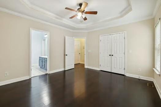 1604 Yarmouth Ct, Old Hickory, TN 37138 - unfurnished bedroom featuring crown molding, wood finished floors, a tray ceiling, a closet, and ensuite bathroom