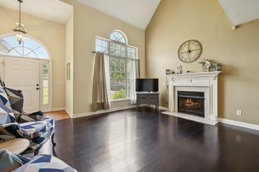 1604 Yarmouth Ct, Old Hickory, TN 37138 - living area featuring high vaulted ceiling, wood finished floors, plenty of natural light, a lit fireplace, and a chandelier