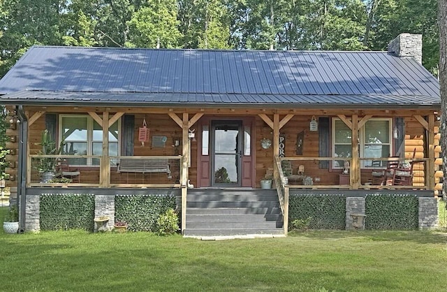 2815 Lewis Chapel Rd, Graysville, TN 37338 - view of front of home featuring a metal roof, a porch, a chimney, and a front yard