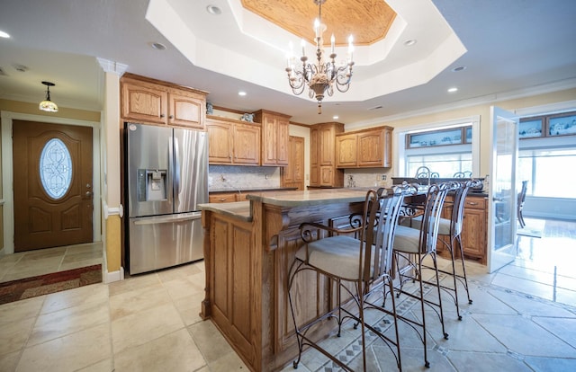 627 Eastbrook Rd, Estill Springs, TN 37330 - kitchen with stainless steel fridge, crown molding, a raised ceiling, tasteful backsplash, and a center island