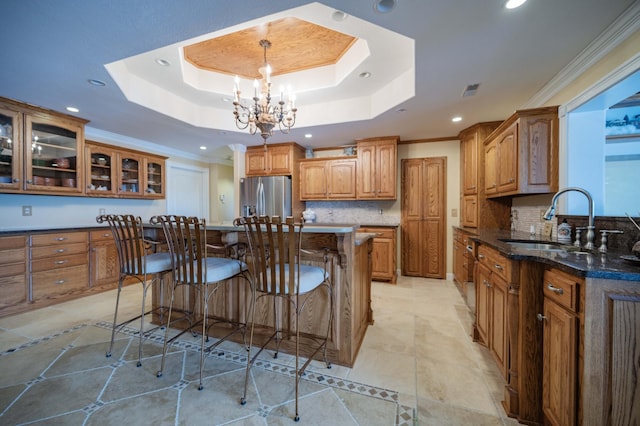 627 Eastbrook Rd, Estill Springs, TN 37330 - kitchen with recessed lighting, brown cabinets, a breakfast bar, tasteful backsplash, and a raised ceiling
