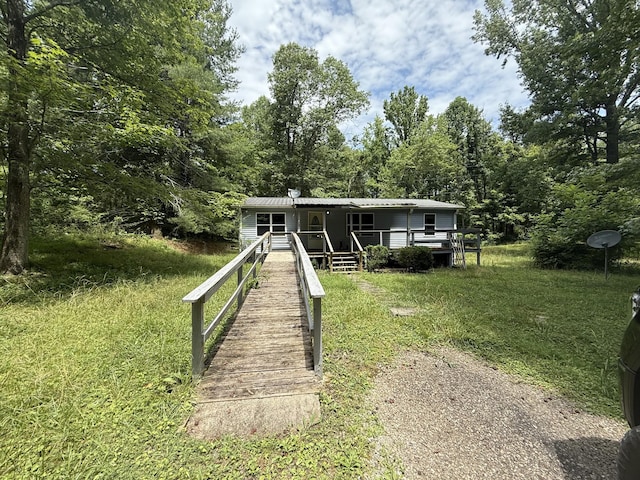 211 Pinetree Rd, Sewanee, TN 37375 - manufactured / mobile home with a metal roof, a porch, and a view of trees