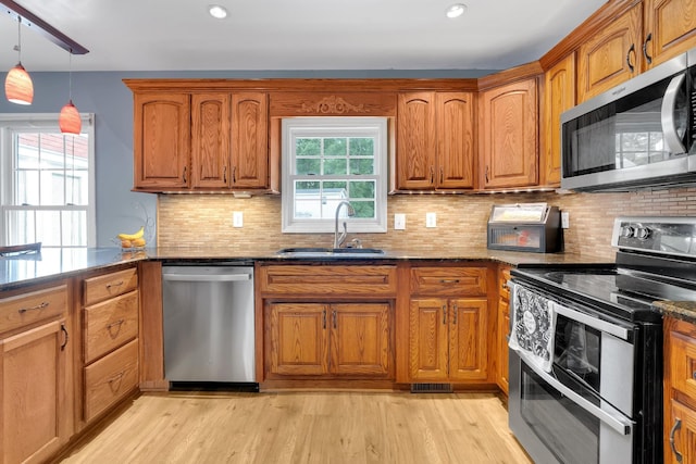 6685 Lynchburg Rd, Winchester, TN 37398 - kitchen with appliances with stainless steel finishes, brown cabinets, dark stone countertops, and recessed lighting