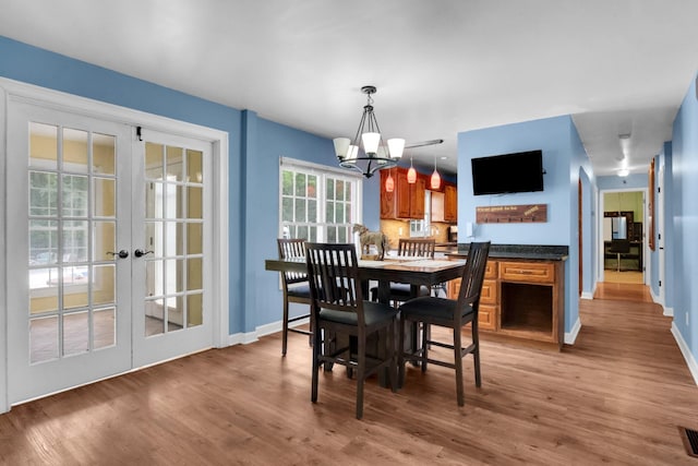 6685 Lynchburg Rd, Winchester, TN 37398 - dining room featuring a chandelier, light wood-style flooring, and french doors