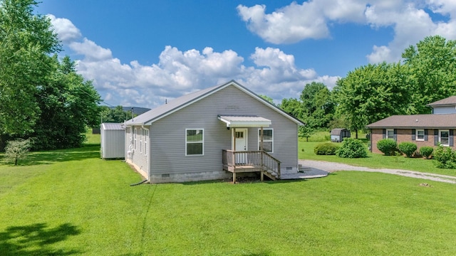 516 Davis St, Cowan, TN 37318 - rear view of house featuring crawl space and a lawn