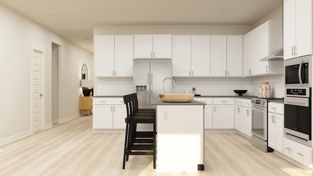 3407 Shigo St, Murfreesboro, TN 37130 - kitchen featuring light wood finished floors, a center island with sink, decorative backsplash, appliances with stainless steel finishes, and white cabinets