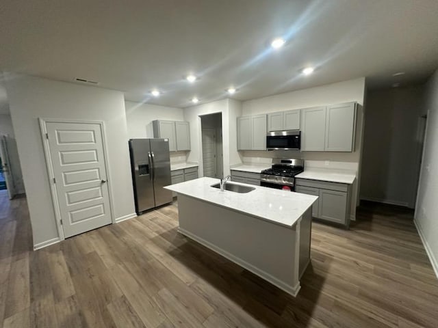 547 Torrey Pines Ln, Lebanon, TN 37087 - kitchen with gray cabinetry, stainless steel appliances, a center island with sink, dark wood finished floors, and recessed lighting