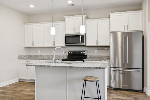 2237 Pathfinder Dr, Murfreesboro, TN 37127 - kitchen with appliances with stainless steel finishes, a kitchen island with sink, white cabinetry, dark wood-style flooring, and light stone countertops