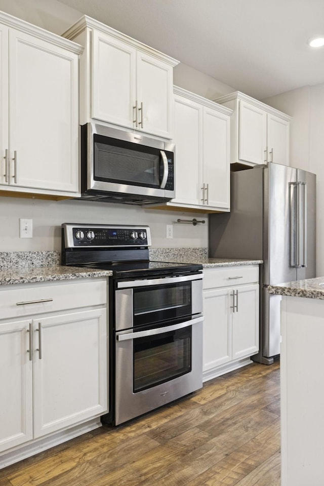 2237 Pathfinder Dr, Murfreesboro, TN 37127 - kitchen with appliances with stainless steel finishes, white cabinetry, dark wood-type flooring, and recessed lighting