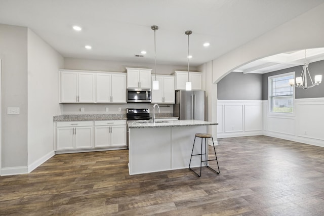 2237 Pathfinder Dr, Murfreesboro, TN 37127 - kitchen with arched walkways, stainless steel appliances, recessed lighting, a center island with sink, and a chandelier