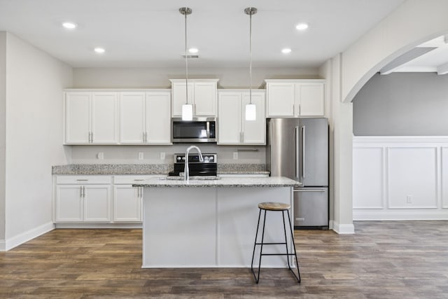 2237 Pathfinder Dr, Murfreesboro, TN 37127 - kitchen featuring stainless steel appliances, arched walkways, a kitchen island with sink, white cabinets, and recessed lighting