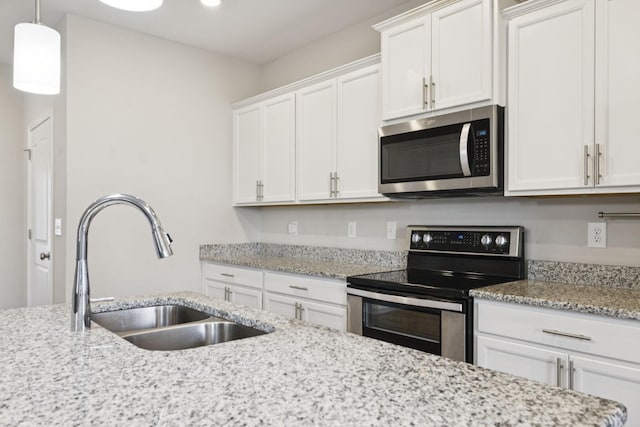 2237 Pathfinder Dr, Murfreesboro, TN 37127 - kitchen featuring appliances with stainless steel finishes, white cabinets, light stone counters, and recessed lighting