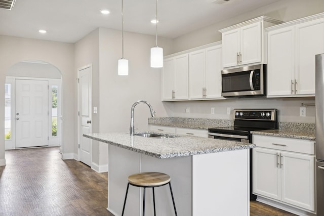 2237 Pathfinder Dr, Murfreesboro, TN 37127 - kitchen with stainless steel appliances, arched walkways, dark wood-type flooring, a kitchen island with sink, and white cabinets