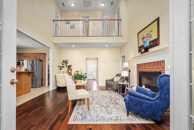 702 John Windrow Rd, Eagleville, TN 37060 - living area featuring a high ceiling, wood-type flooring, and a brick fireplace