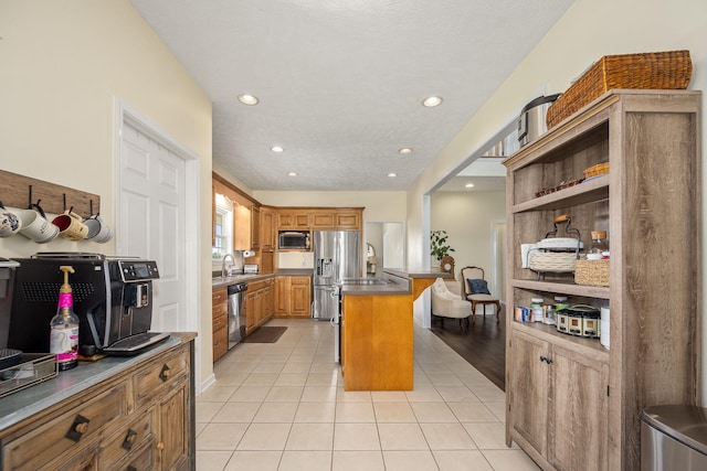 702 John Windrow Rd, Eagleville, TN 37060 - kitchen featuring dark countertops, light tile patterned floors, brown cabinetry, recessed lighting, and appliances with stainless steel finishes
