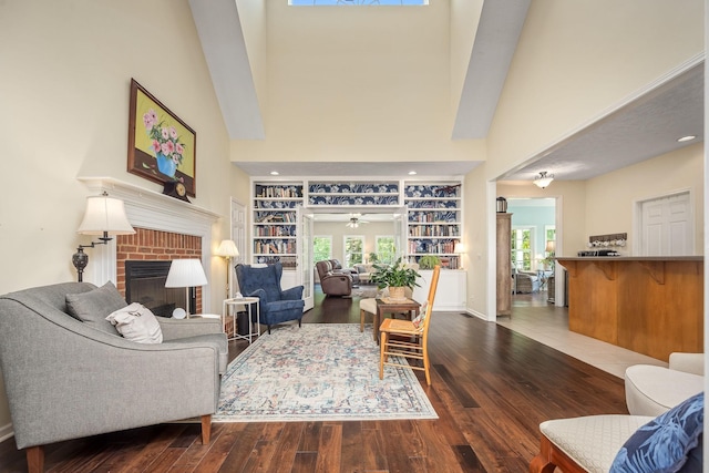 702 John Windrow Rd, Eagleville, TN 37060 - living area with a brick fireplace, wood finished floors, built in features, and a towering ceiling
