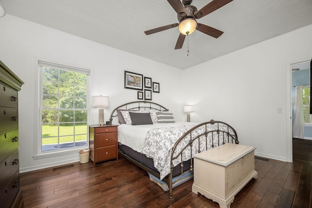 702 John Windrow Rd, Eagleville, TN 37060 - bedroom with dark wood-style flooring, multiple windows, and ceiling fan
