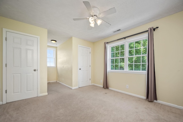 702 John Windrow Rd, Eagleville, TN 37060 - unfurnished bedroom featuring light colored carpet, a textured ceiling, and a ceiling fan