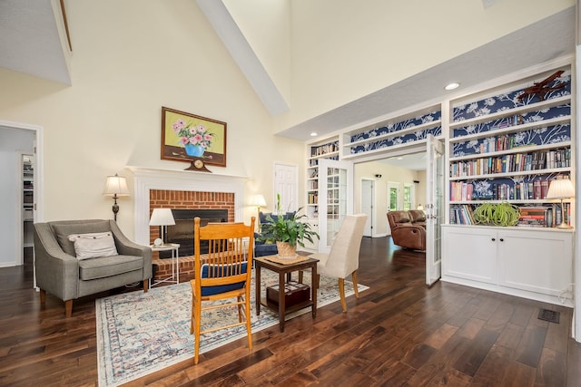 702 John Windrow Rd, Eagleville, TN 37060 - living area with dark wood-style flooring, a fireplace, a towering ceiling, and recessed lighting