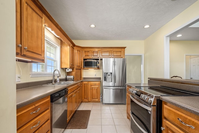 702 John Windrow Rd, Eagleville, TN 37060 - kitchen with appliances with stainless steel finishes, brown cabinets, dark countertops, light tile patterned floors, and recessed lighting