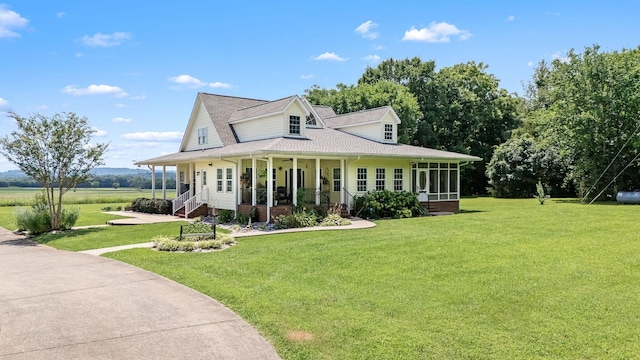 702 John Windrow Rd, Eagleville, TN 37060 - country-style home with a front lawn, covered porch, a shingled roof, and a sunroom