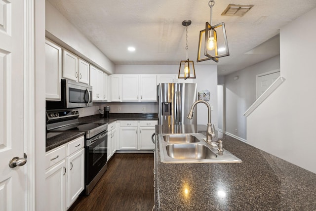 4826 Chelanie Cir, Murfreesboro, TN 37129 - kitchen with stainless steel appliances, dark countertops, white cabinets, hanging light fixtures, and recessed lighting