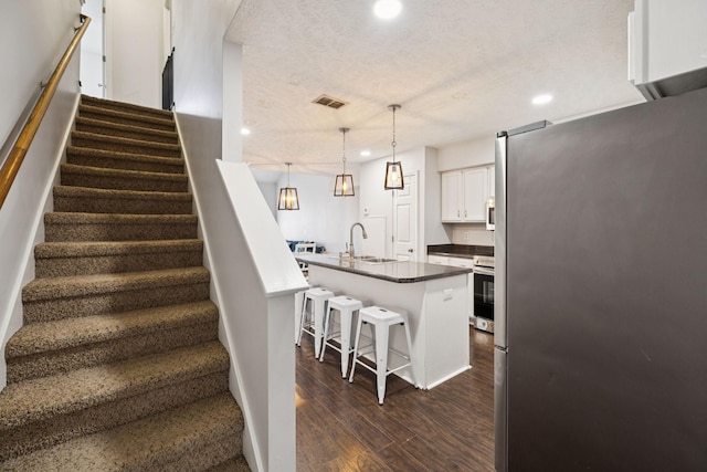 4826 Chelanie Cir, Murfreesboro, TN 37129 - staircase with recessed lighting, wood finished floors, and a textured ceiling