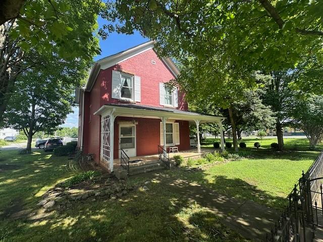 103 Cowan St W, Cowan, TN 37318 - view of front of home with covered porch and a front yard