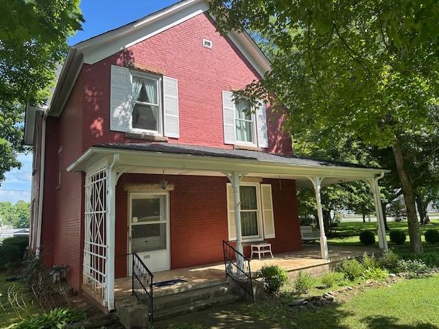 103 Cowan St W, Cowan, TN 37318 - view of front of house featuring brick siding and covered porch
