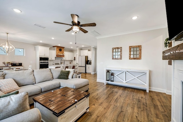 3612 Shady Forest Dr, Murfreesboro, TN 37128 - living room featuring a ceiling fan, crown molding, a chandelier, wood finished floors, and recessed lighting