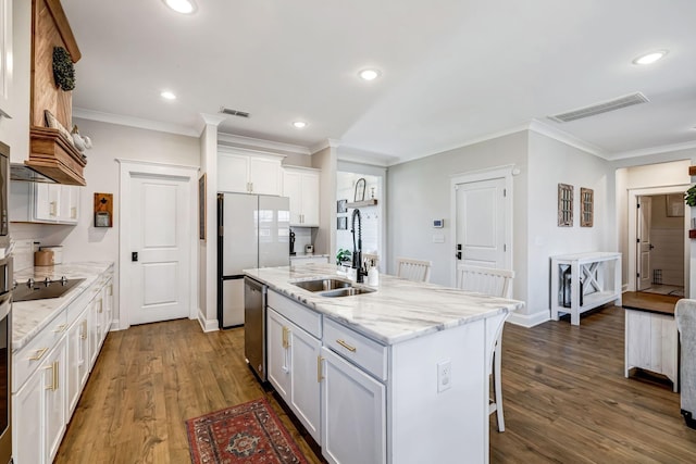 3612 Shady Forest Dr, Murfreesboro, TN 37128 - kitchen featuring ornamental molding, dark wood-type flooring, white cabinetry, light stone counters, and a kitchen island with sink