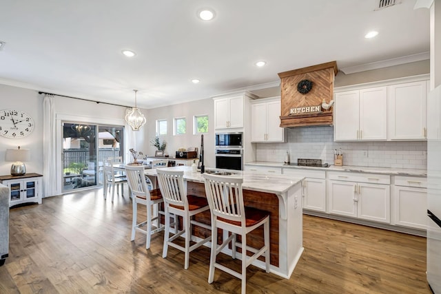 3612 Shady Forest Dr, Murfreesboro, TN 37128 - kitchen with ornamental molding, a kitchen island with sink, decorative backsplash, white cabinets, and recessed lighting