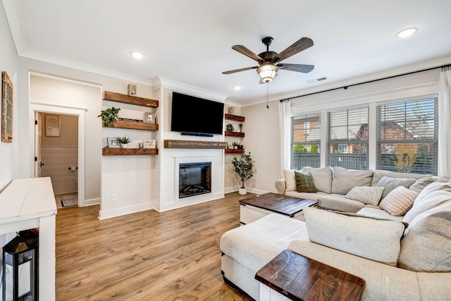 3612 Shady Forest Dr, Murfreesboro, TN 37128 - living area featuring a large fireplace, a ceiling fan, light wood-style floors, crown molding, and recessed lighting