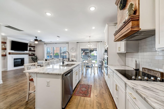3612 Shady Forest Dr, Murfreesboro, TN 37128 - kitchen with a kitchen breakfast bar, stainless steel appliances, white cabinets, a ceiling fan, and a large fireplace
