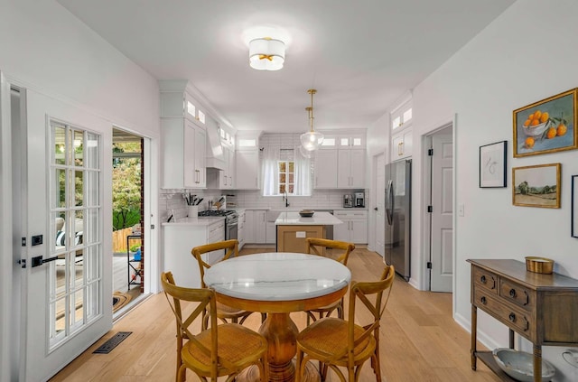 720 N Wickshire Way, Brentwood, TN 37027 - dining area with light wood-style flooring and plenty of natural light