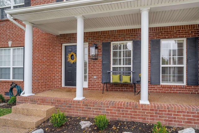 720 N Wickshire Way, Brentwood, TN 37027 - doorway to property featuring brick siding and covered porch